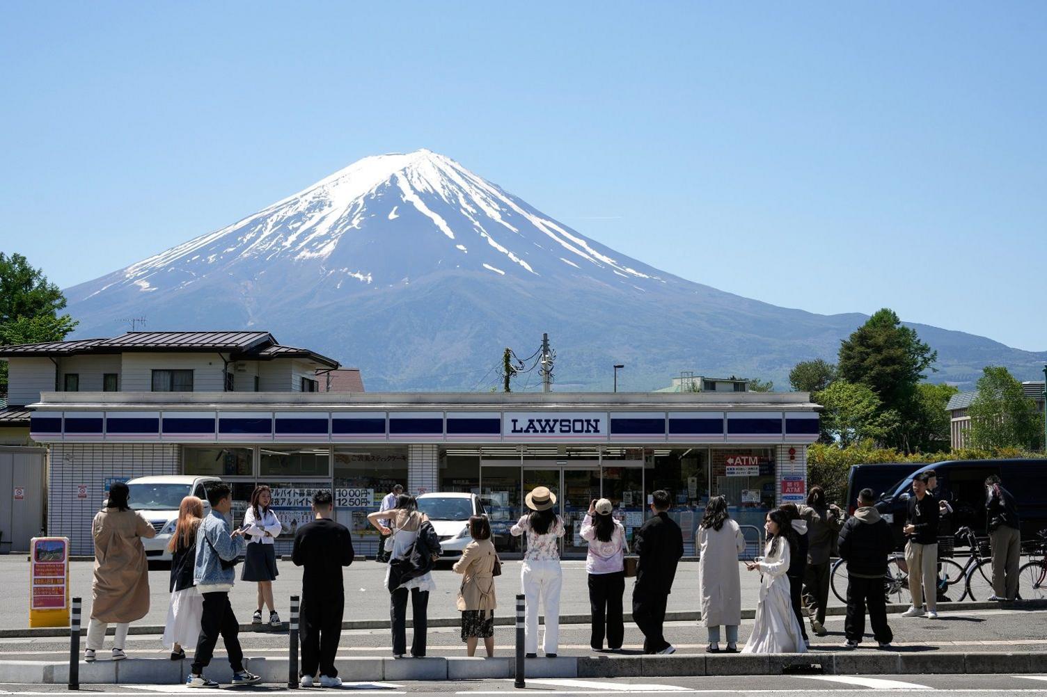 Mount Fuji climber rescued twice after going back for lost phone.