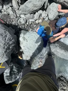 A 700-pound boulder pinned Alaska man face down in a glacier creek for 3 hours.
