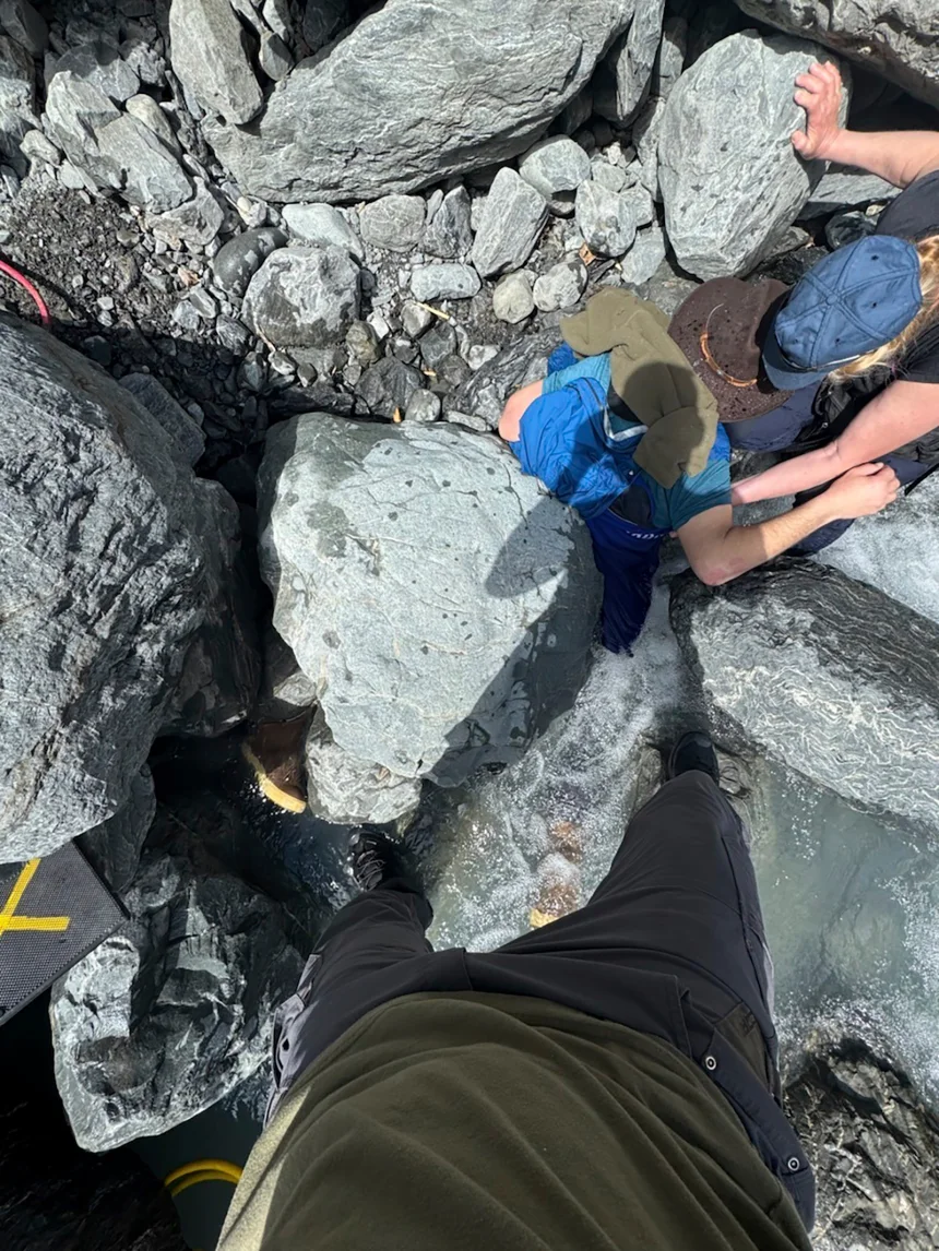 A 700-pound boulder pinned Alaska man face down in a glacier creek for 3 hours.