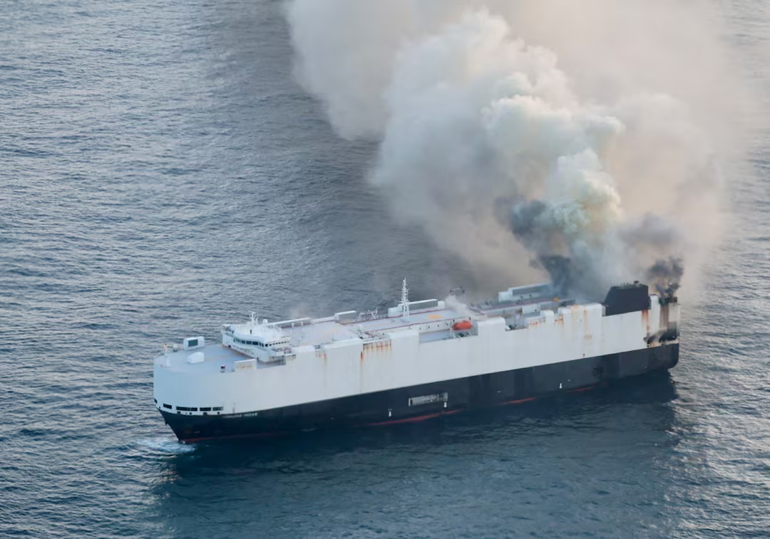 Burning cargo ship carrying 3,000 vehicles abandoned off Alaska.
