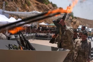 Kurdish PKK militants burn weapons in landmark step to end decades-long Turkey conflict.