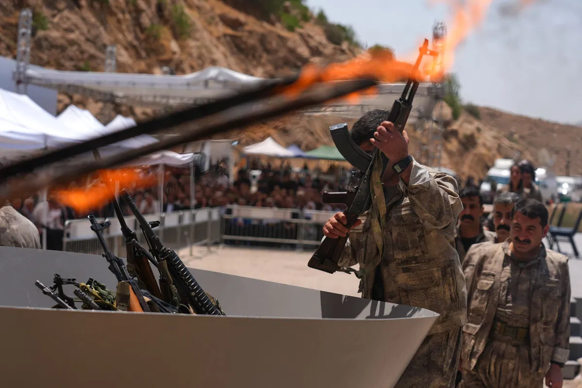 Kurdish PKK militants burn weapons in landmark step to end decades-long Turkey conflict.