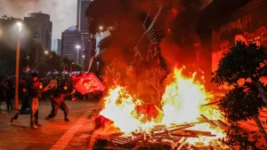 Three dead after protests over death of taxi driver in Indonesia.