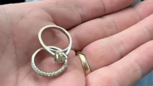 Man finds wife's lost wedding rings after searching through landfill.