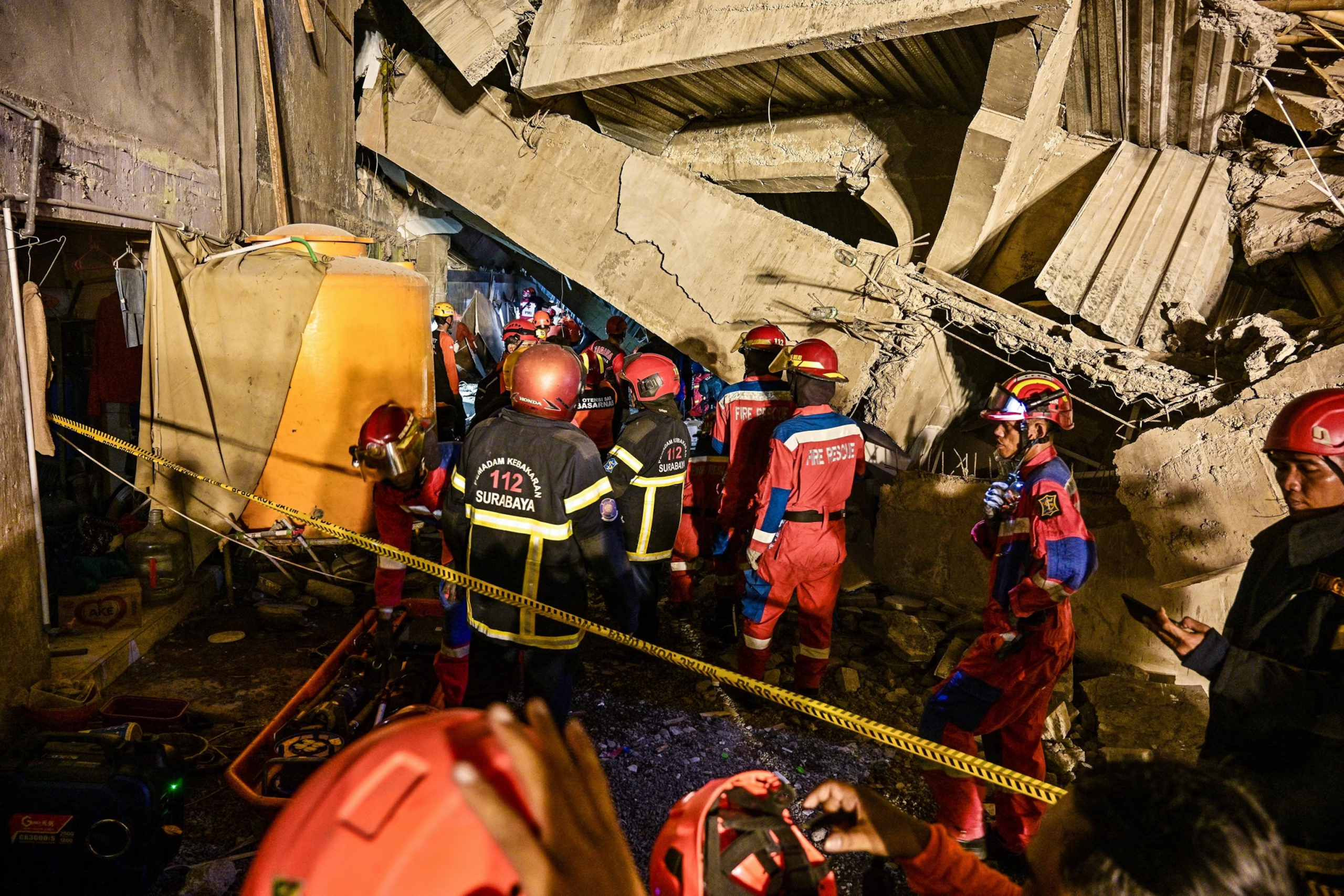 Three dead, dozens trapped after Indonesian school collapses on students.