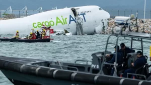 Two dead after cargo plane skids off Hong Kong runway into sea.