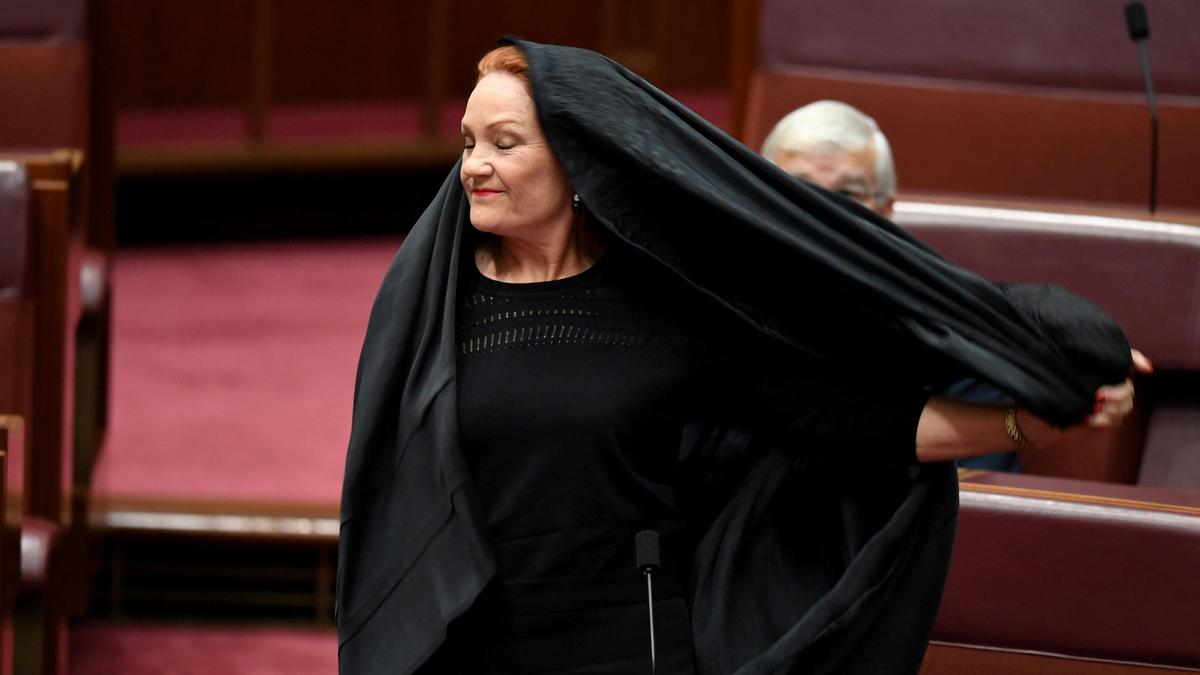 Australia senator suspended after burka stunt in parliament.