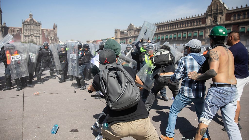Thousands protest against government in Mexico as clashes leave 120 injured.