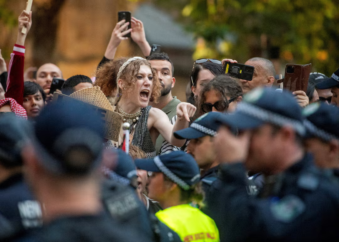 Australia police defend actions after violence at protest over Israeli president visit.