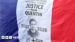 Demonstrators in Paris carried flags calling for justice during a rally paying tribute to Quentin Deranque over the weekend.