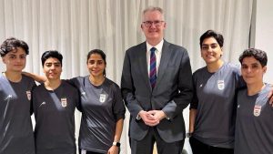 Australian Home Affairs Minister Tony Burke with the five players who have been granted humanitarian visas.