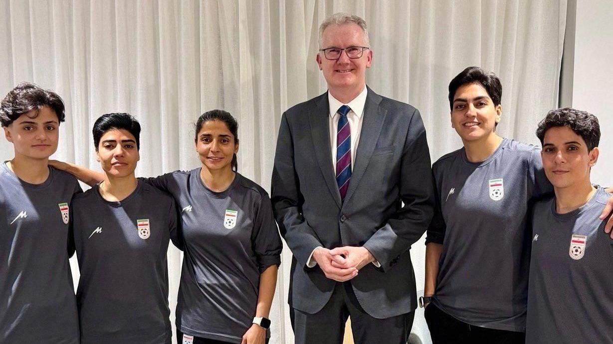 Australian Home Affairs Minister Tony Burke with the five players who have been granted humanitarian visas.
