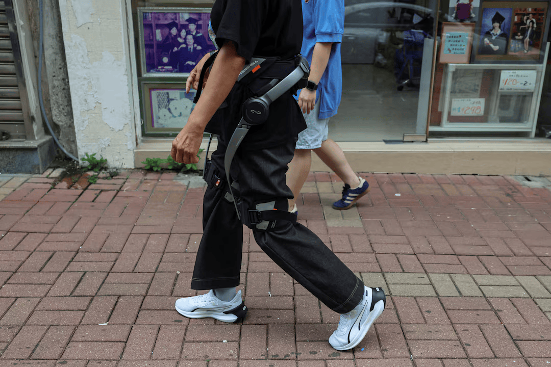 Robotic legs help elderly Hong Kong fire survivors climb back for belongings.
