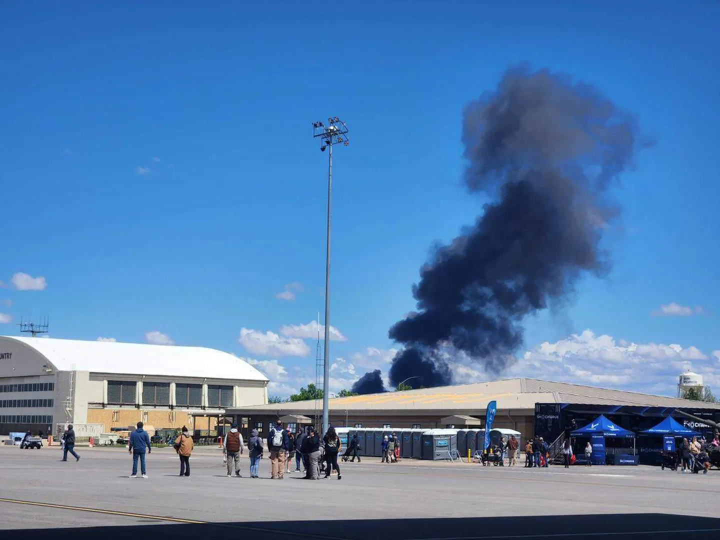Fighter jet crews parachute safely after collision at US air show.