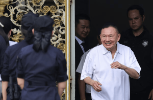 Former Thai Prime Minister Thaksin Shinawatra reacts following his release on parole after serving eight months of his one-year sentence at Klong Prem Central Prison, in Bangkok, Thailand, May 11, 2026.