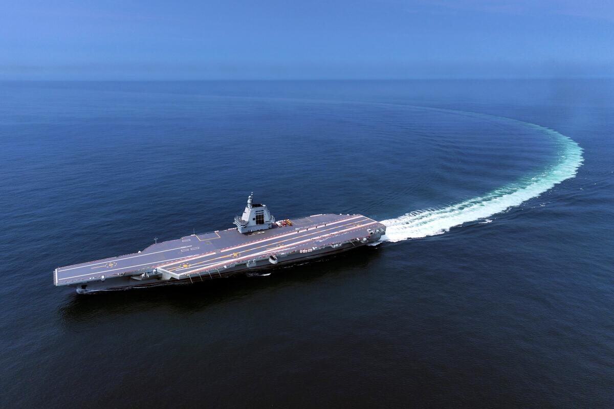 China's most advanced aircraft carrier sails through Taiwan Strait, Taipei says.
