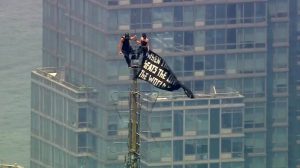 Russian daredevils unfurl banner atop New York's Empire State Building in proposal stunt.