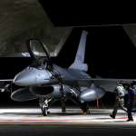 A pilot and Air Force soldier run towards a F-16V fighter jet for an evening take off as part of a combat readiness mission at the airbase in Hualien, Taiwan, August 17, 2022.