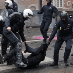 Police detain a demonstrator as student protesters join a nationwide strike against the Belgian government's austerity measures and budget cuts, in Brussels, Belgium, October 9, 2026.