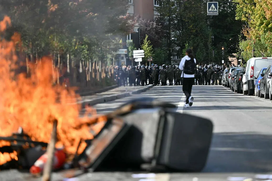 Students torch two schools as protests rage across France.