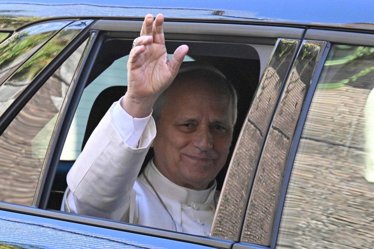 Pope Leo XIV waves as he leaves the Vatican before being admitted to Rome's Gemelli University Hospital for an operation on Tuesday.